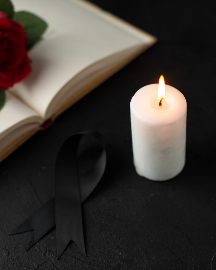 front-view-red-rose-with-open-book-candle-black